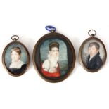 A SET OF THREE MINIATURE PORTRAITS ON IVORY in brass oval glazed frames, the largest measuring 8cm