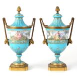 A PAIR OF LATE 19th CENTURY FRENCH ORMOLU MOUNTED SERVES LIDDED URNS having rams head handles on
