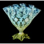 A STYLISH VASELINE GLASS CRIMPED SHAPED VASE with leaf-shaped moulded foot  16cm high.