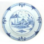 A LATE 18th CENTURY BLUE AND WHITE DELFT CHARGER with Chinese village scene to centre  36cm diameter