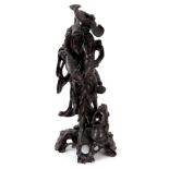 A 19TH CENTURY JAPANESE CARVED HARDWOOD SCULPTURE OF A FISHERMAN with freshly caught fish, on a