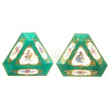 A PAIR OF 19th CENTURY FRENCH TRIANGULAR SERVES PLATES having green ground with gilt decoration