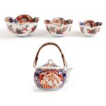 A SET OF THREE 19th CENTURY IMARI GRADUATED LOTUS SHAPED BOWLS decorated with leaf-work polychrome