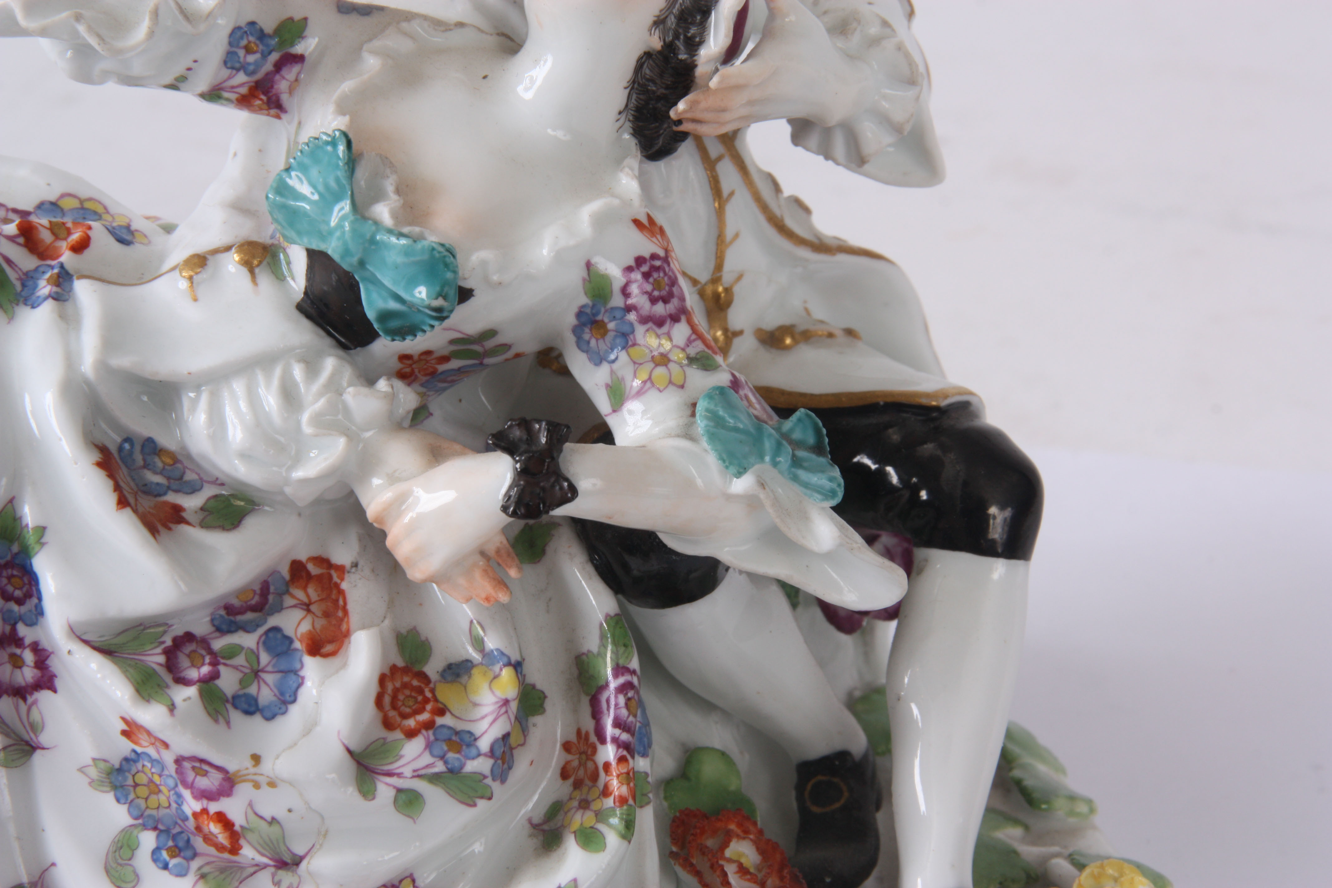 A MID 18TH CENTURY MEISSEN FIGURE GROUP of two lovers sat amongst flowers, brightly decorated with a - Image 3 of 6