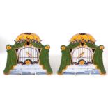 A PAIR OF EARLY 19TH CENTURY DELFT HANGING PLAQUES decorated with canaries sat in bird cages,