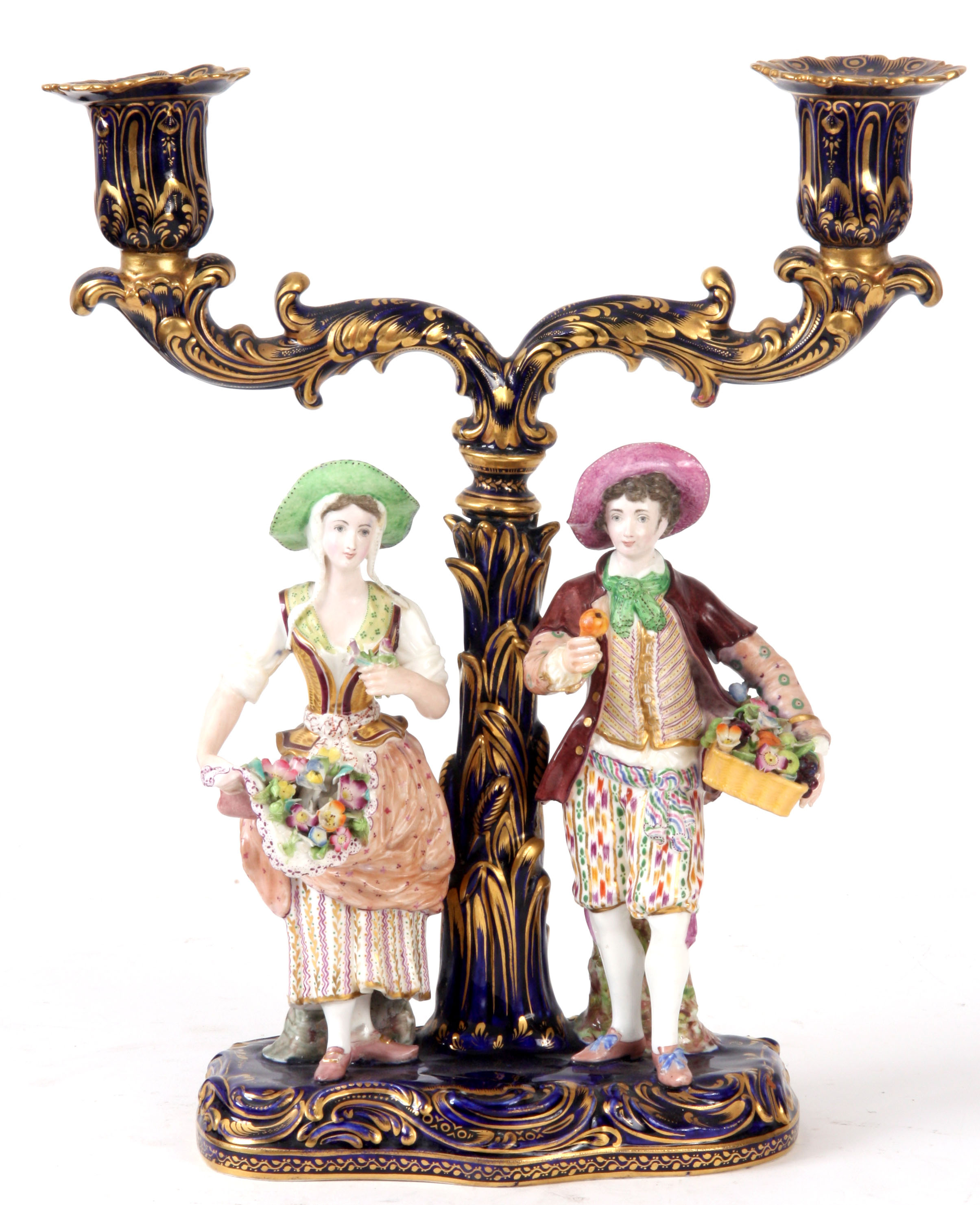 A 19TH CENTURY MINTON TWO BRANCH CANDELABRA on Royal blue ground with gilt decoration, supporting