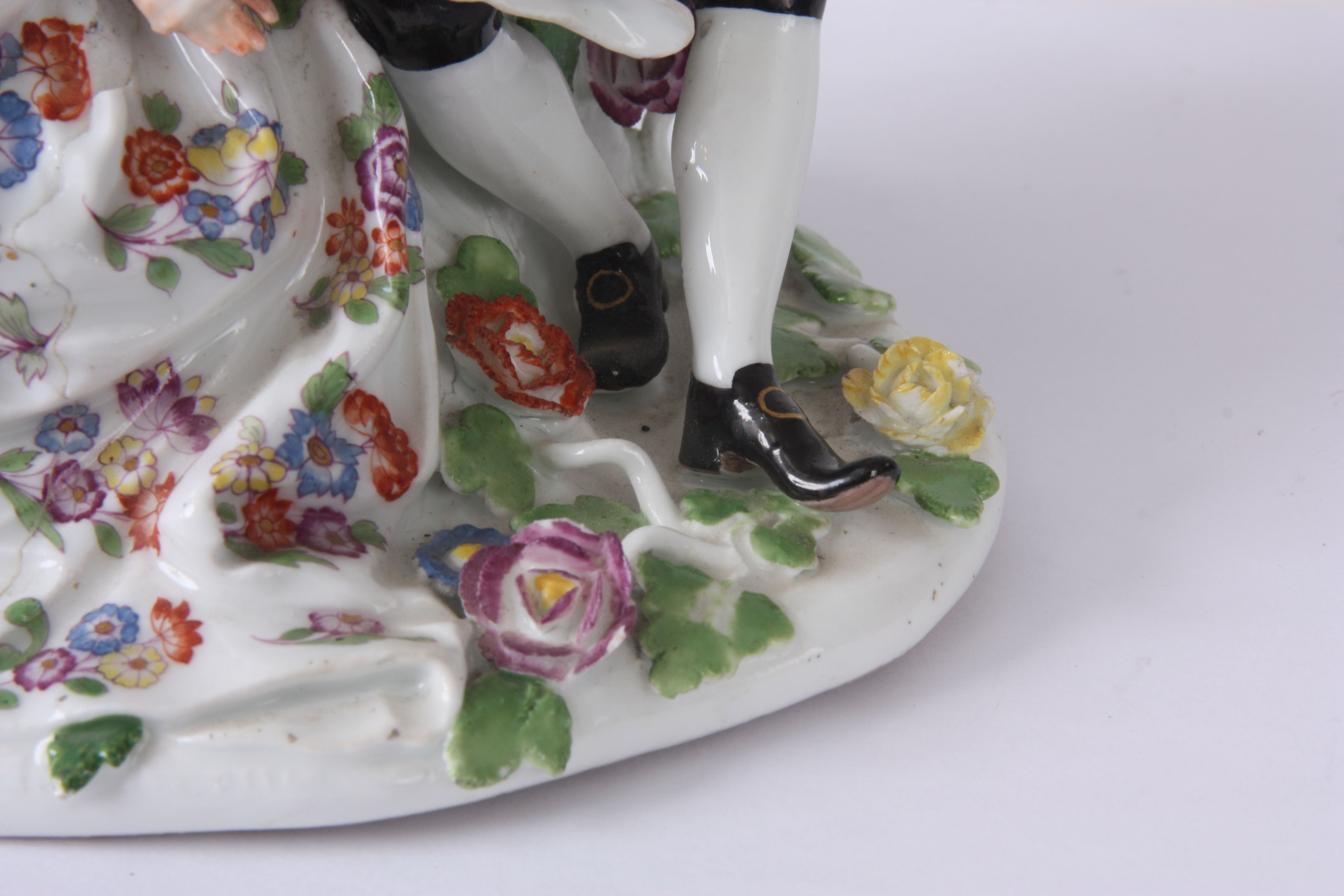 A MID 18TH CENTURY MEISSEN FIGURE GROUP of two lovers sat amongst flowers, brightly decorated with a - Image 5 of 6