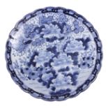 A LARGE 19th CENTURY BLUE AND WHITE CHINESE IMARI CHARGER with scalloped edge, decorated with flying