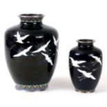 A LARGE AND SMALL BLUE GROUND EARLY 20th CENTURY JAPANESE CLOISONNE VASES depicting white cranes