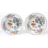 A PAIR OF 18TH CENTURY ITALIAN FAIENCE PLATES with dished bodies and decorated with brightly