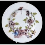 AN EARLY 18TH CENTURY LIVERPOOL DELFT CHARGER decorated with coloured branchwork and butterfly