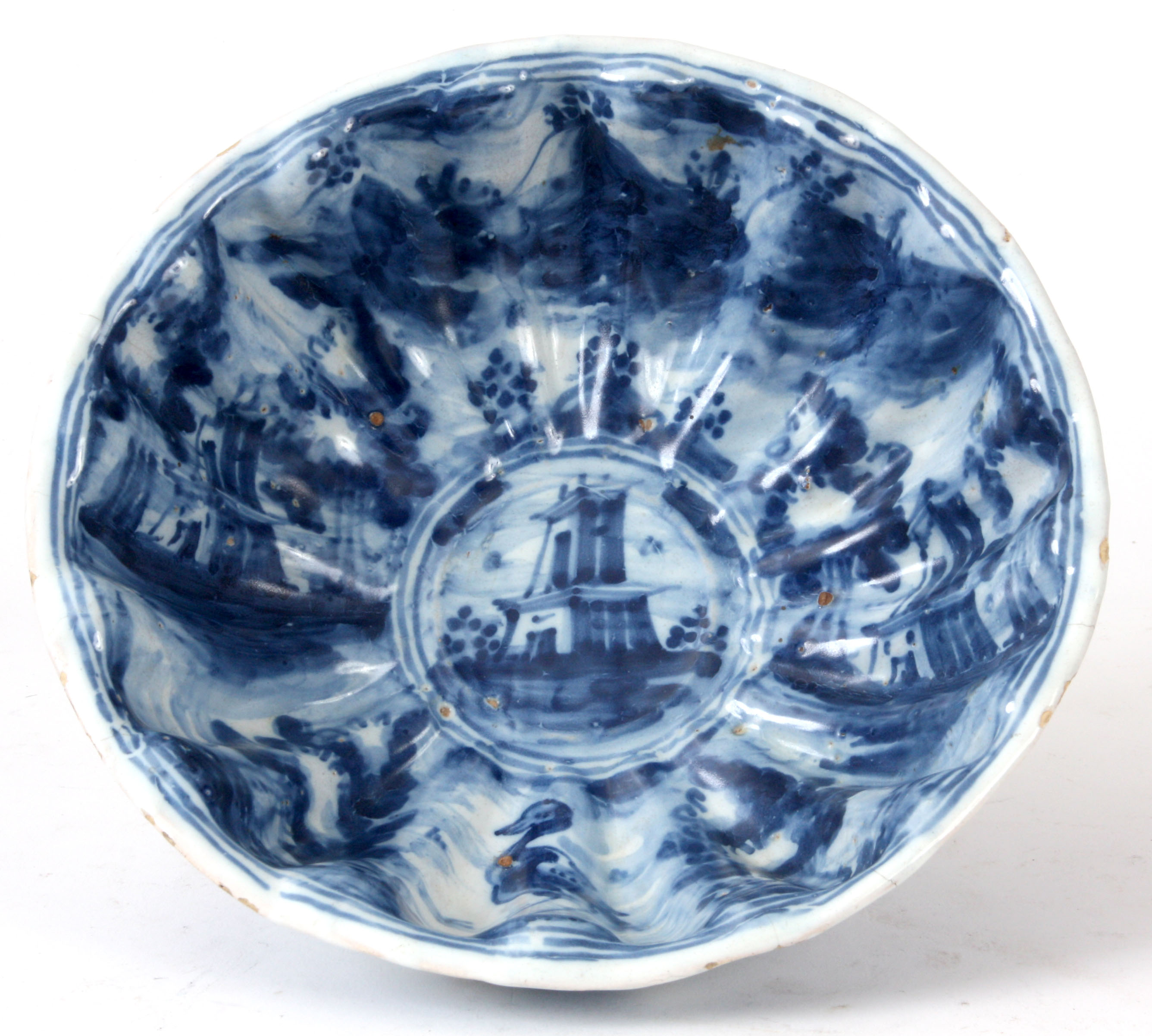 A 19TH CENTURY BLUE AND WHITE ITALIAN FAIENCE POTTERY  BOWL of reeded shaped form decorated with