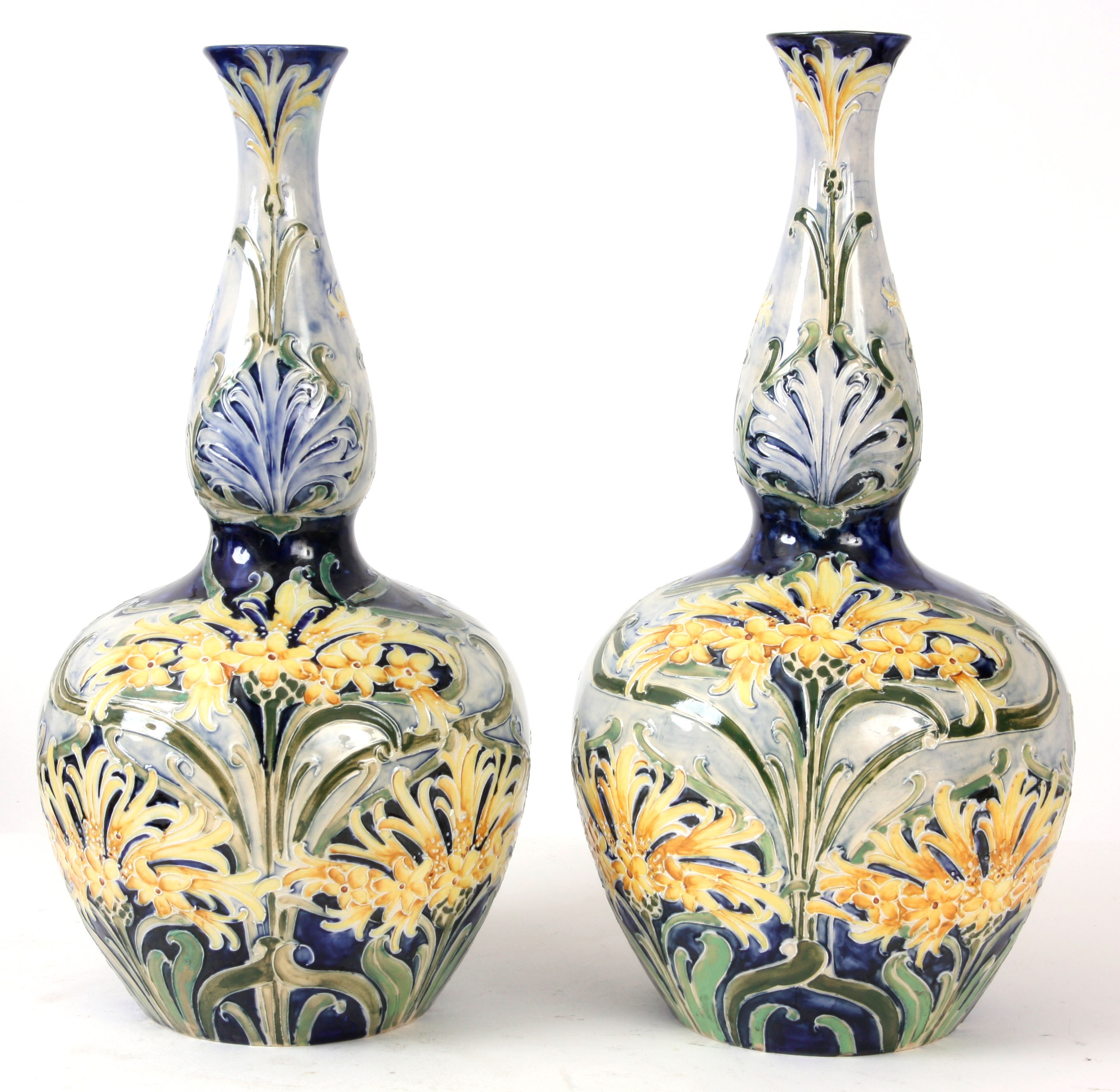 WILLIAM MOORCROFT, A LARGE PAIR OF FLORIAN GROUND MOORCROFT BULBOUS VASES tubeline decorated with
