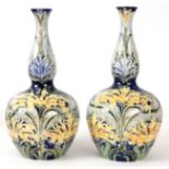 WILLIAM MOORCROFT, A LARGE PAIR OF FLORIAN GROUND MOORCROFT BULBOUS VASES tubeline decorated with