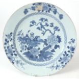 AN 18TH CENTURY CHINESE PORCELAIN BLUE AND WHITE CHARGER with floral branchwork and antiquities in