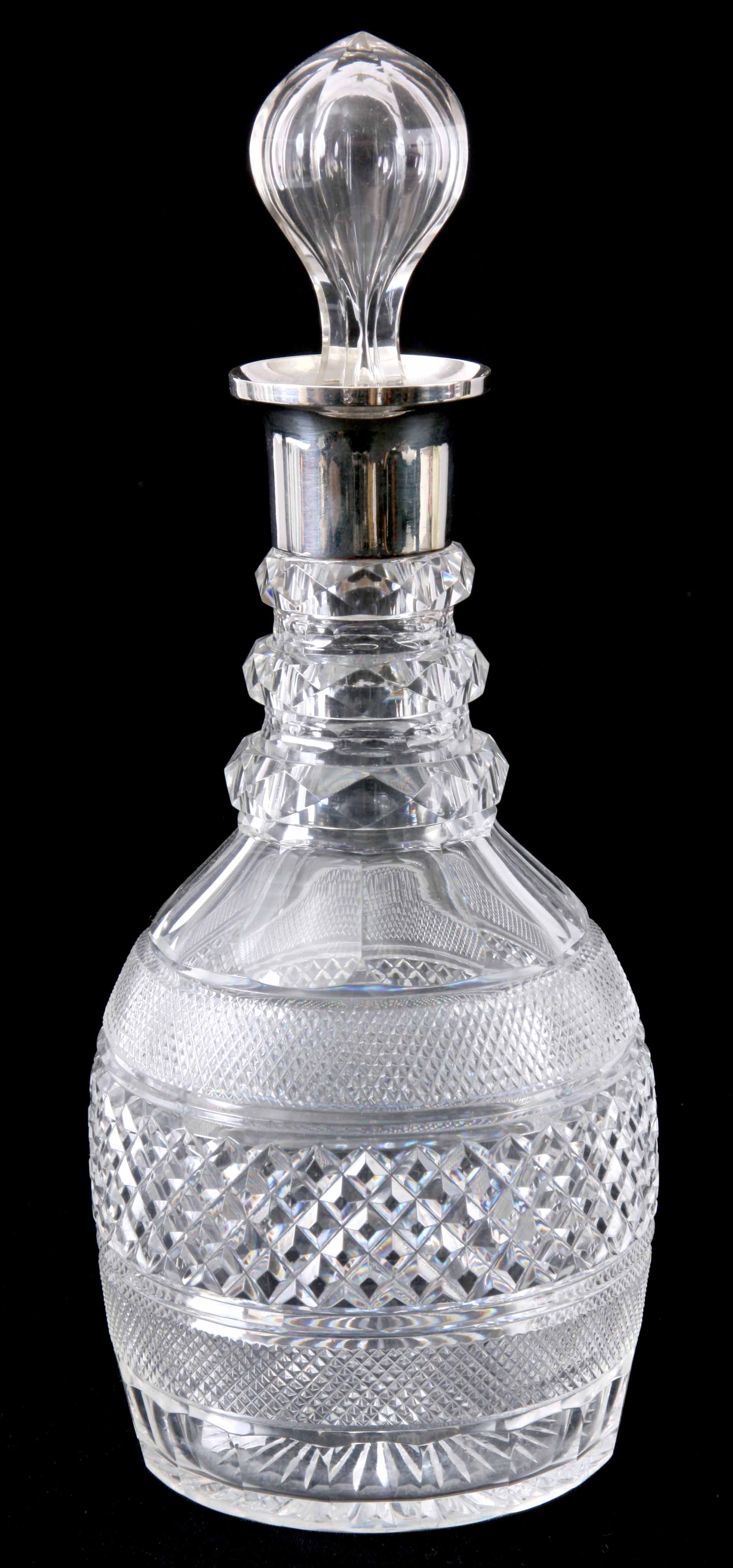 A SILVER MOUNTED GLASS CUT DECANTER with bulbous stopper - London 1908 31cm high.