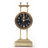 AN EARLY 20th CENTURY ENGLISH BRASS CASED GRAVITY CLOCK with 3.25" glass dial 26cm high