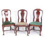 THREE SIMILAR EARLY GEORGIAN WALNUT SIDE CHAIRS POSSIBLY BY GILES GRENEDY with rounded C scroll