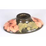 A WALTER MOORCROFT HIBISCUS PATTERN CANDLE HOLDER with peach coloured flowers on a green ground