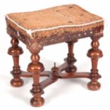 A 19TH CENTURY QUEEN ANNE STYLE WALNUT STOOL with baluster shaped leg supports joined by a X