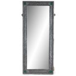 AN ARTS AND CRAFTS PEWTER RECTANGULAR HANGING MIRROR with hammered decorated frame and green jewel