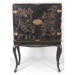 AN EARLY 18TH CENTURY BLACK JAPANNED AND CHINOISERIE DECORATED CABINET ON LATER STAND with shaped