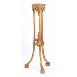 A LATE 19TH CENTURY ADAM STYLE GILT GESSO TORCHERE with circular top above a tripod splayed leg base