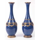 A STYLISH PAIR OF SERVES ORMOLU MOUNTED PORCLELAIN VASES with Royal blue ground and mounted with