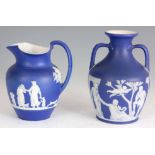 A WEDGWOOD BLUE AND WHITE JASPERWARE TWO HANDLED PORTLAND VASE and a MATCHING EWER each with
