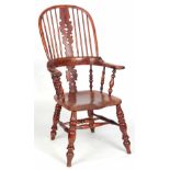 AN EARLY 19TH CENTURY BROAD ARM YEW-WOOD WINDSOR ARMCHAIR with hooped back and shaped Christmas tree