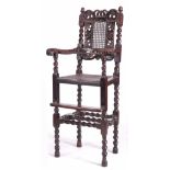 A CHARLES II WALNUT CHILDS HIGH CHAIR of pegged barley-twist construction with caned seat and back