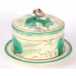 A 19TH CENTURY ENGLISH MAJOLICA CHEESE DISH AND COVER with a cream ground decorated with fern leaves