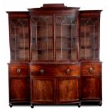 A GOOD LATE REGENCY EBONY LINED FIGURED MAHOGANY SECTIONAL BREAKFRONT LIBRARY BOOKCASE WITH BOWFRONT