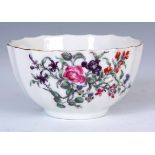AN UNUSUAL 18TH CENTURY FIRST PERIOD WORCESTER FLUTED POLYCHROME TEA BOWL with delicate flower spray