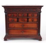 A GEORGE III LANCASHIRE ELM AND MAHOGANY CROSS-BANDED MINATURE CHEST OF DRAWERS with moulded edge