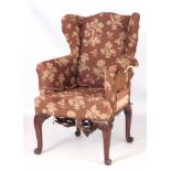 A FINE EARLY GEORGE III MAHOGANY FRAMED UPHOLSTERED CHIPPENDALE STYLE WING BACK ARM CHAIR on four