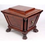 A STYLISH REGENCY MAHOGANY SARCOPHAGUS WINE COOLER of tapering panelled form with free standing