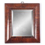 A SMALL WILLIAM AND MARY FIGURED WALNUT CUSHION FRAMED HANGING MIRROR with short grained moulded