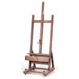 A LARGE MID 20TH CENTURY ELM ADJUSTABLE EASEL with rack and pinion adjustment, tilting back, pull