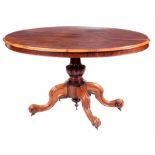 A MID 19TH CENTURY FIGURED ROSEWOOD OVAL TILT TOP CENTRE TABLE with moulded edge above a carved