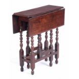A RARE LATE 17TH CENTURY WALNUT DROP LEAF GATE LEG TABLE OF SMALL SIZE with end drawer; standing