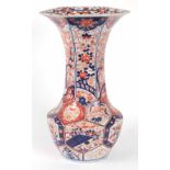 A LARGE 19TH CENTURY IMARI VASE with hexagonal shaped flared neck on a bulbous circular base,