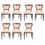 A SET OF SEVEN GEORGE IV ROSEWOOD GILLOWS STYLE DINING CHAIRS having carved scrollwork backs leaf