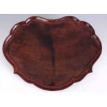 A GEORGE II MAHOGANY TRAY with scollop shaped raised moulded edge 51.5cm diameter