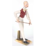 AN EARLY 20th CENTURY AUSTRIAN POTTERY FIGURE OF A BILLIARDS / SNOOKER PLAYER faintly impressed