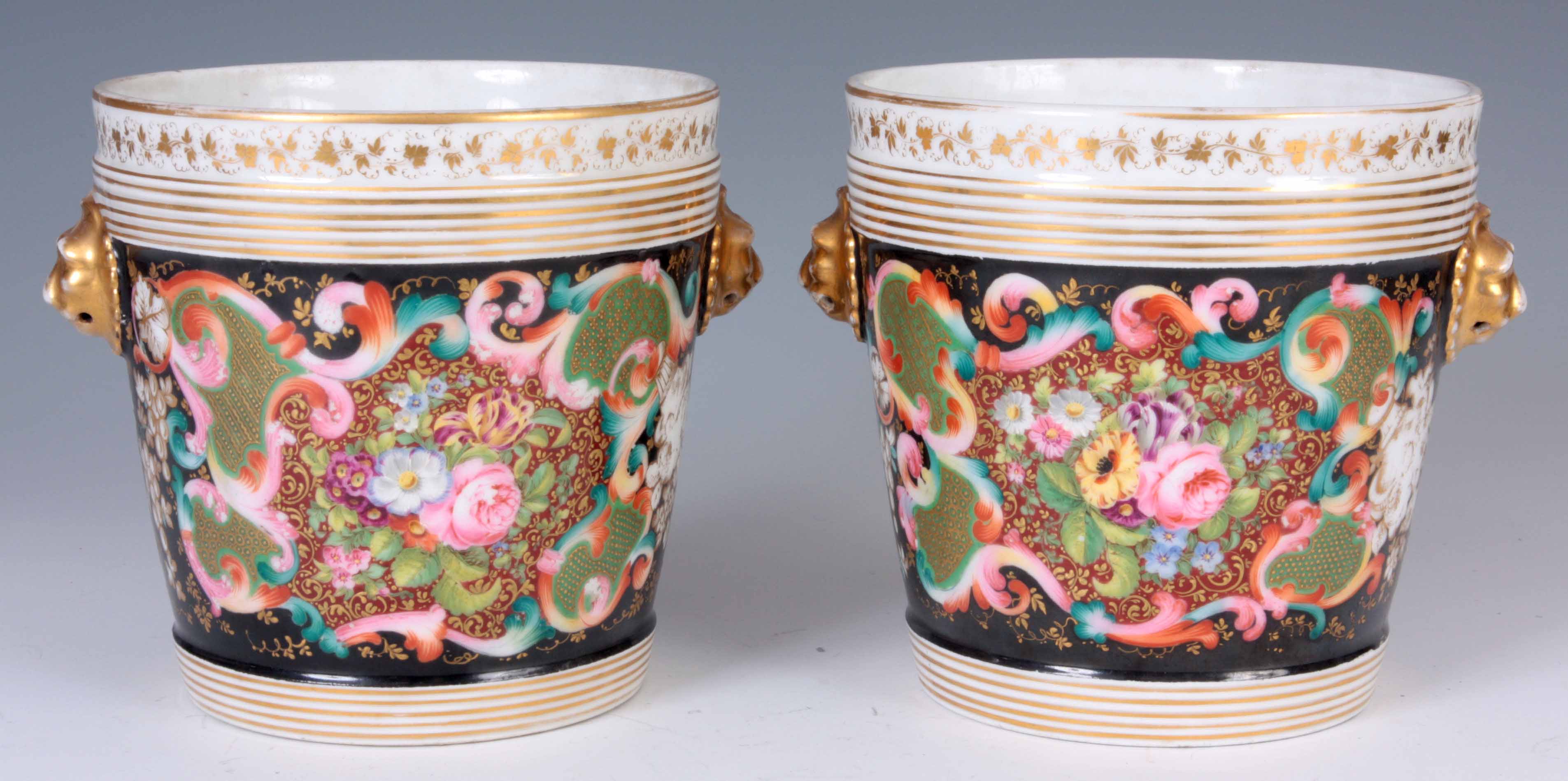 A PAIR OF 19TH CENTURY PARIS PORCELAIN ICE PAILS decorated with flowers with gilt lions mask handles