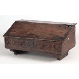 A 17TH CENTURY OAK SLOPE FRONT DESK BOX INITIALLED E H AND DATED 1689 fitted iron butterfly hinges