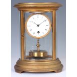 CLAUDE GRIVOLAS. AN EARLY 20th CENTURY BRASS OVAL CASED FOUR GLASS 400 DAY MANTEL CLOCK the gilt