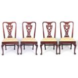 A SET OF 4 EARLY GEORGIAN WALNUT CHAIRS with interlaced pierced vase shaped splats, drop in seats
