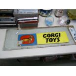Vintage Corgi Toys sign mounted on glass panel